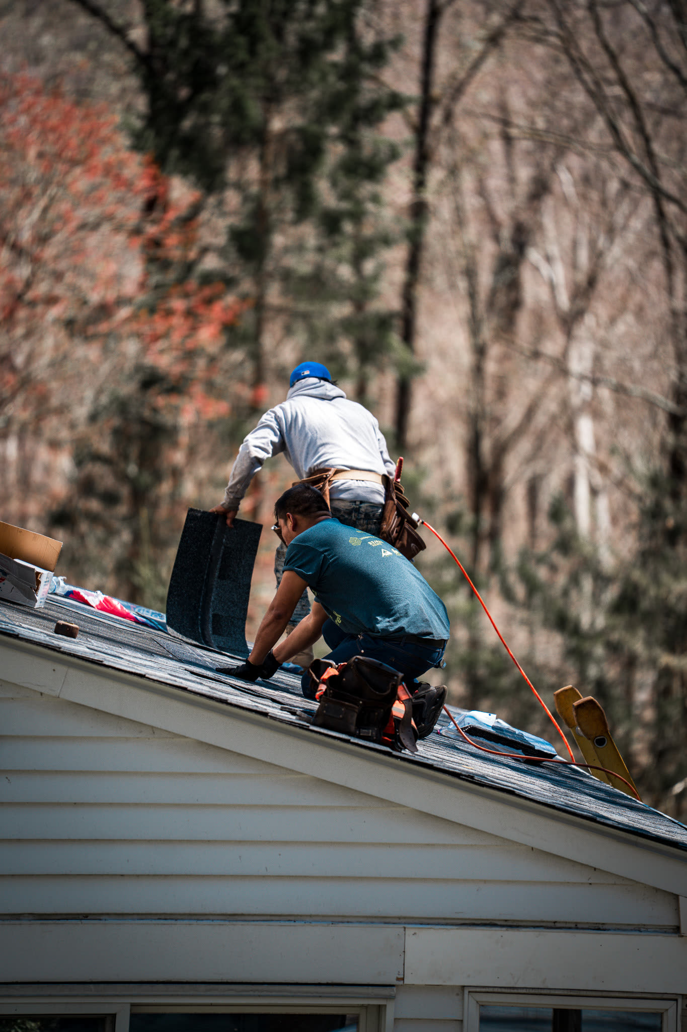 Crew installing new shingles